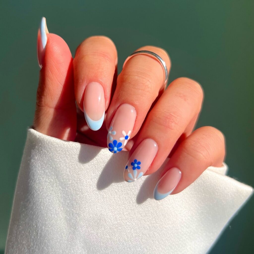 Sheer Pink Almond Nails with Baby Blue French Tips and Blue Daisy Floral Nail Ideas for Spring