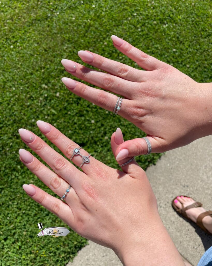 Sheer pink almond nails with rhinestones romantic bridal nail ideas with subtle sparkle