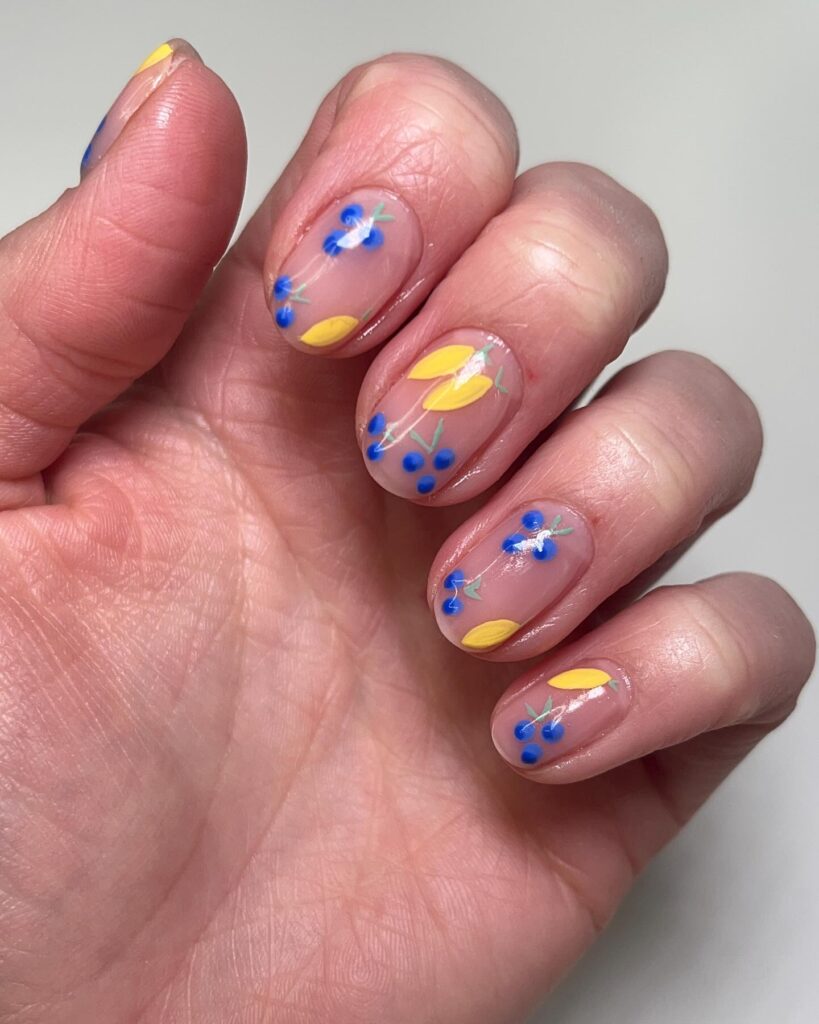 Short Natural Nails with Yellow and Blue Floral Art for a Soft, Garden-Inspired Design
