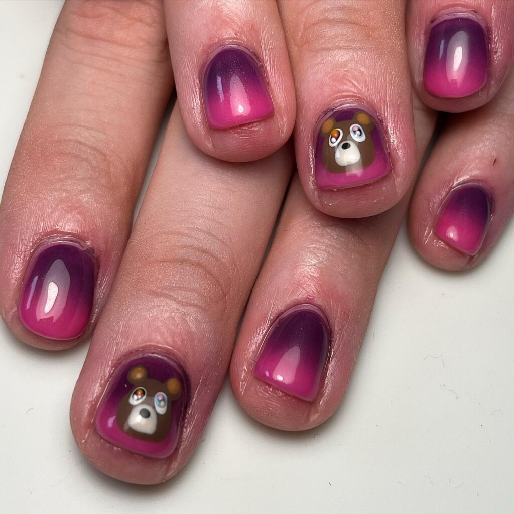 Short Rounded Nails in Purple-Pink Ombre with Cute Hand-Painted Teddy Bear Faces for a Playful Graduation Design