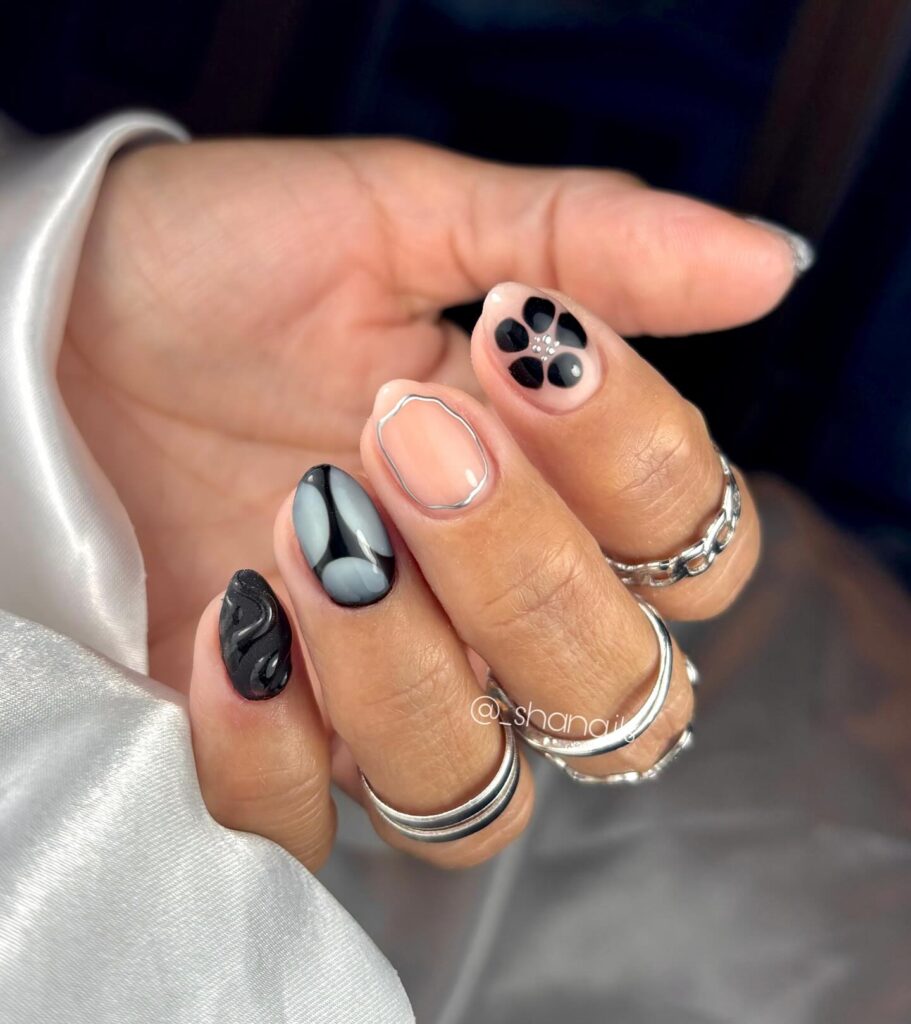 Short Almond Black and Silver Birthday Nails with Textured Swirls, Pearl Floral Details, and Minimalist Abstract Geometry