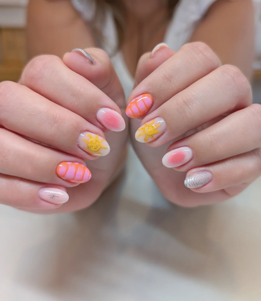 Short almond nude nails with gradient stripes and sun and star details for a cheerful summer nail idea