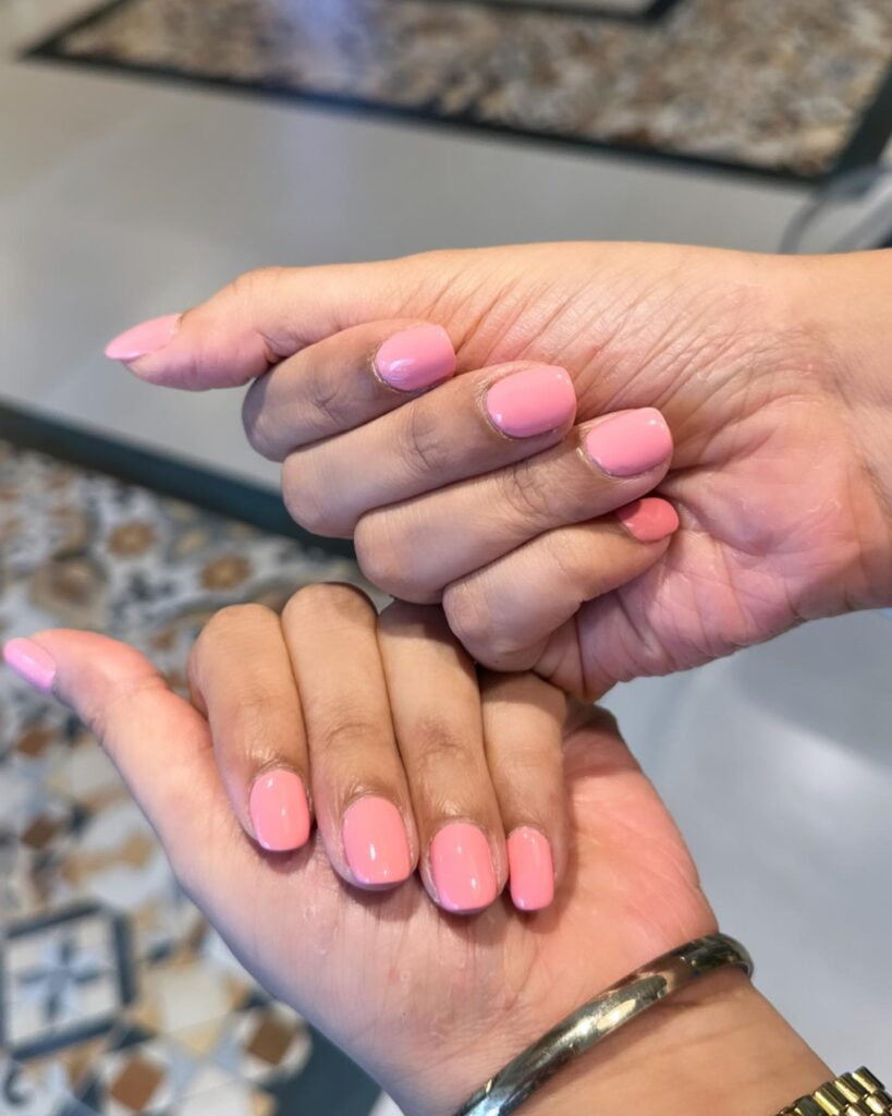 Short Natural Shaped Nails in Creamy Pink with a Polished Glossy Finish for Classic Charm