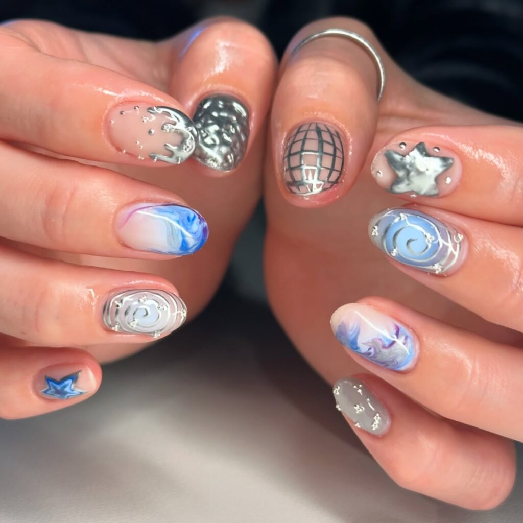 Short oval galaxy nails in silver and blue – creative graduation nail ideas for trendsetters