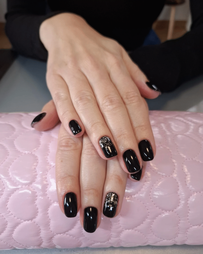 Short Rounded Black Nails with Silver Glitter Accents – Chic Glam Nail Idea for Evening Looks