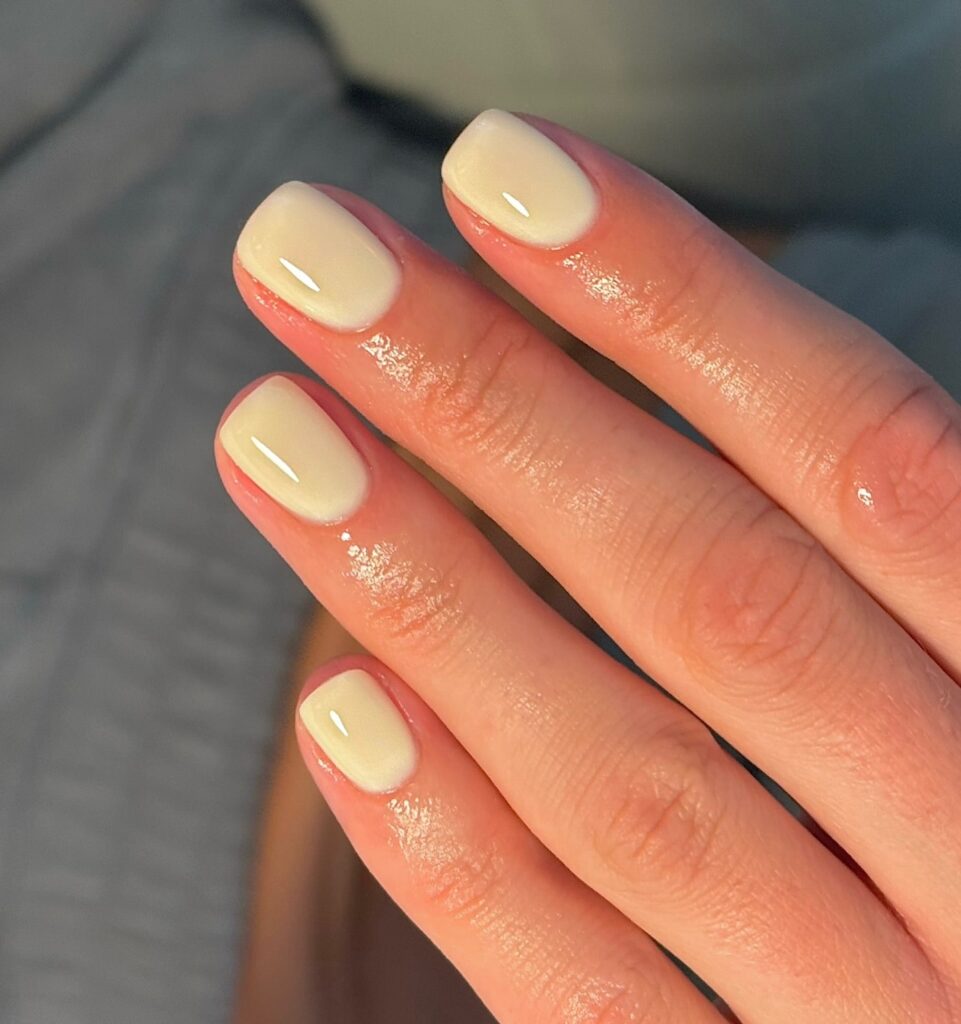 Short square pastel yellow nails with a glossy finish for an elegant everyday nail idea