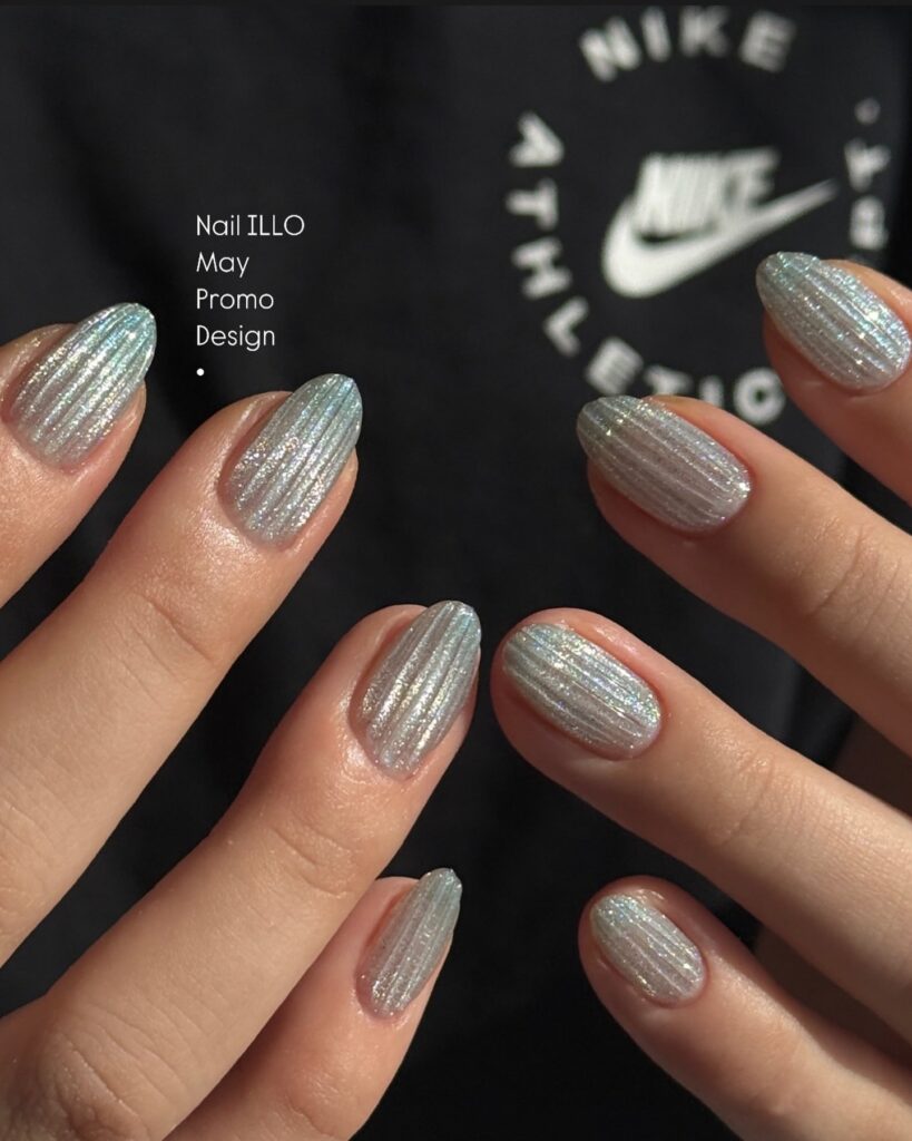 Silver Chrome Ribbed Nails with a Holographic Shine on Almond Tips