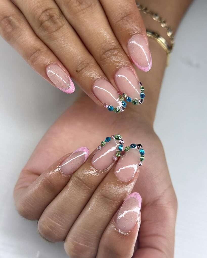 Soft Nude Almond Nails with Pink Glitter Tips and Multicolor Rhinestone Accents for Graduation