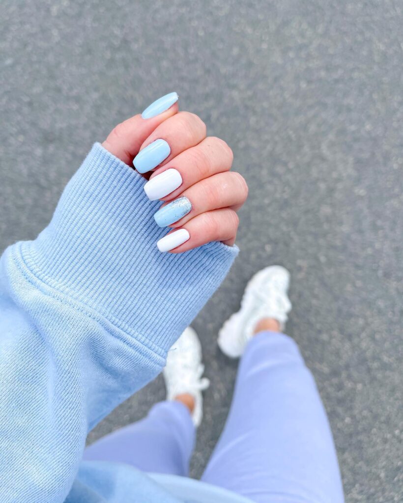 Soft Baby Blue and White Almond Nails with Glitter Accents for a Breezy Spring Vibe