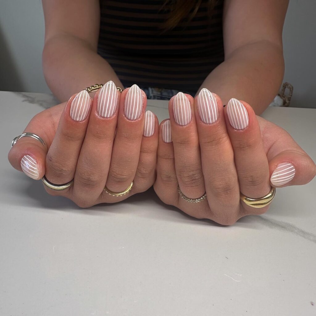 Soft Nude and White Striped Almond Nails Inspired by Classic Tailoring