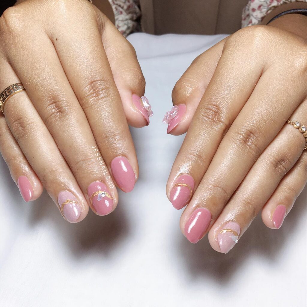Soft oval pink nails with gold swirls and 3d florals – romantic graduation nail inspiration