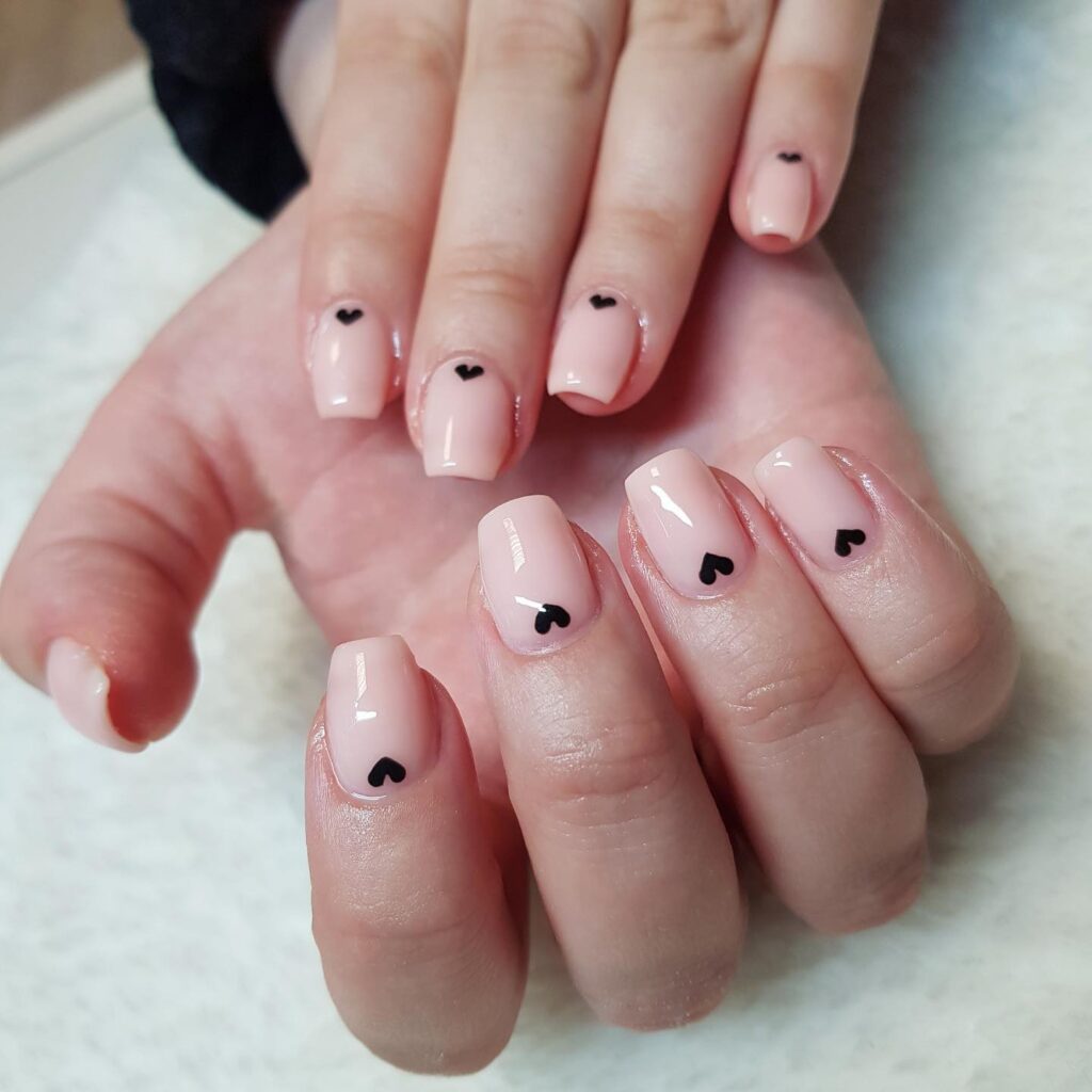Square Nude Pink Nails with Black Heart Accents for Romantic and Subtle Flirty Looks
