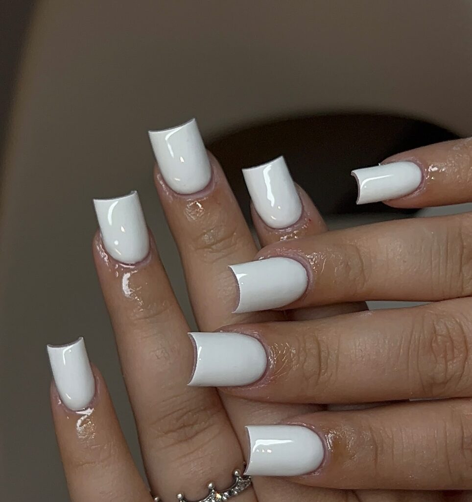 Square shaped crisp white nails for a modern and fresh nail look