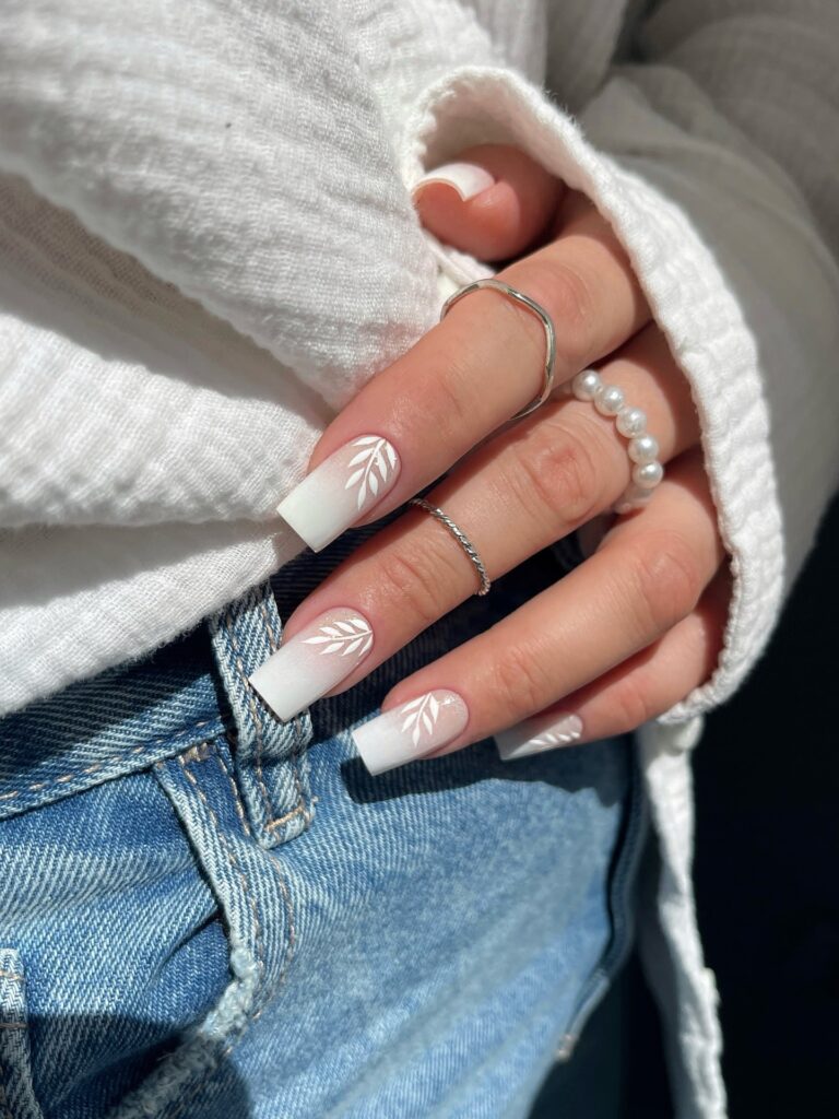 White Ombré Square Nails with Leaf Accents and a Matte Finish for Natural Charm
