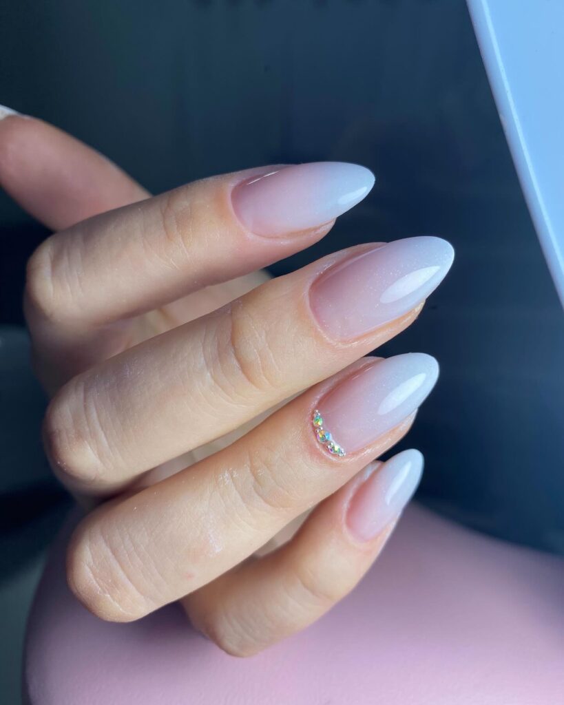 Almond Milky White Ombre Nails with Rhinestone Cuticle Accents