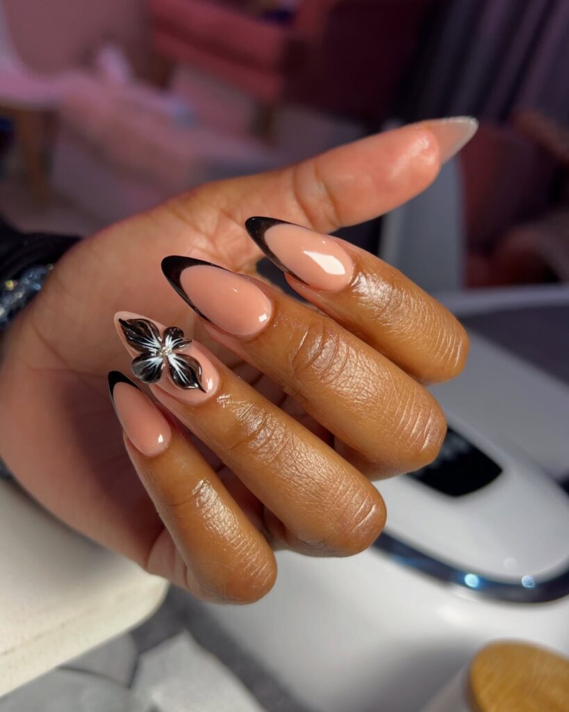 Almond Nude Nails with Black French Tips and 3D Floral Accents for Graduation