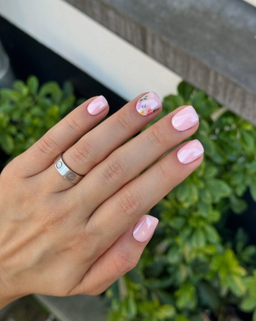 Baby pink rounded nails with hand painted floral accents delicate spring wedding nail ideas
