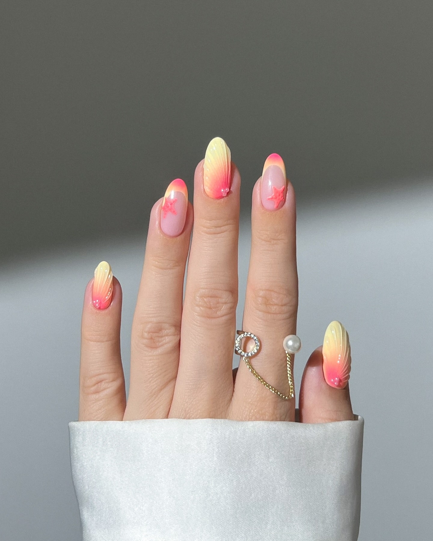 Beachy Almond Nails with Yellow to Coral Gradient and 3D Seashell and Starfish Details