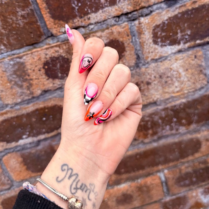 Bold Almond Birthday Nail Art with Neon Swirls, Smiley Faces, and Orange Tips