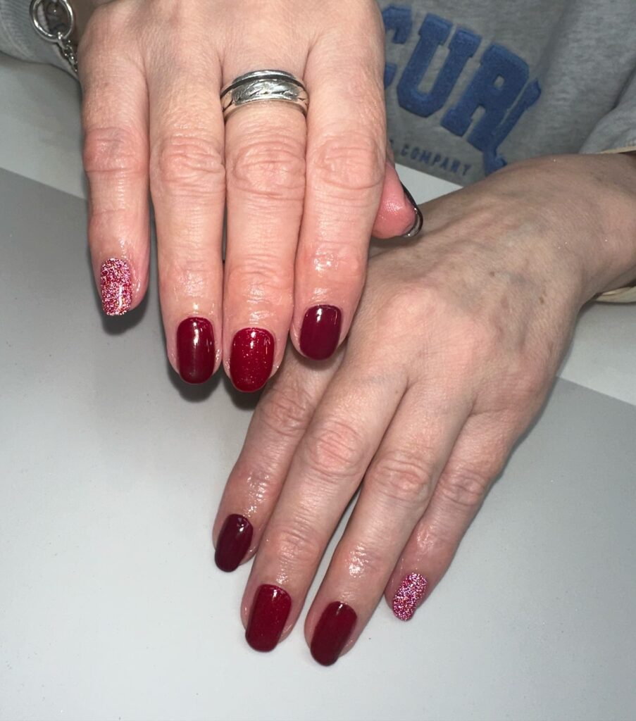 Burgundy and Glitter Accent Nails in a Rounded Shape