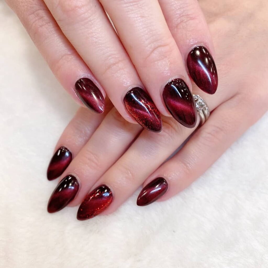Burgundy Cat Eye Nails with Magnetic Shine for Glamorous Winter Nail Ideas