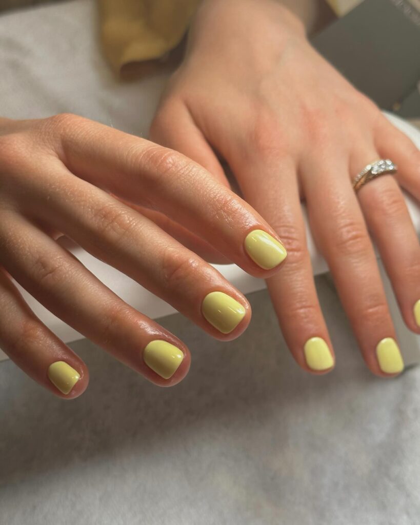 Buttery Yellow Rounded Nails With Glossy Finish for a Classic Spring Nail Idea