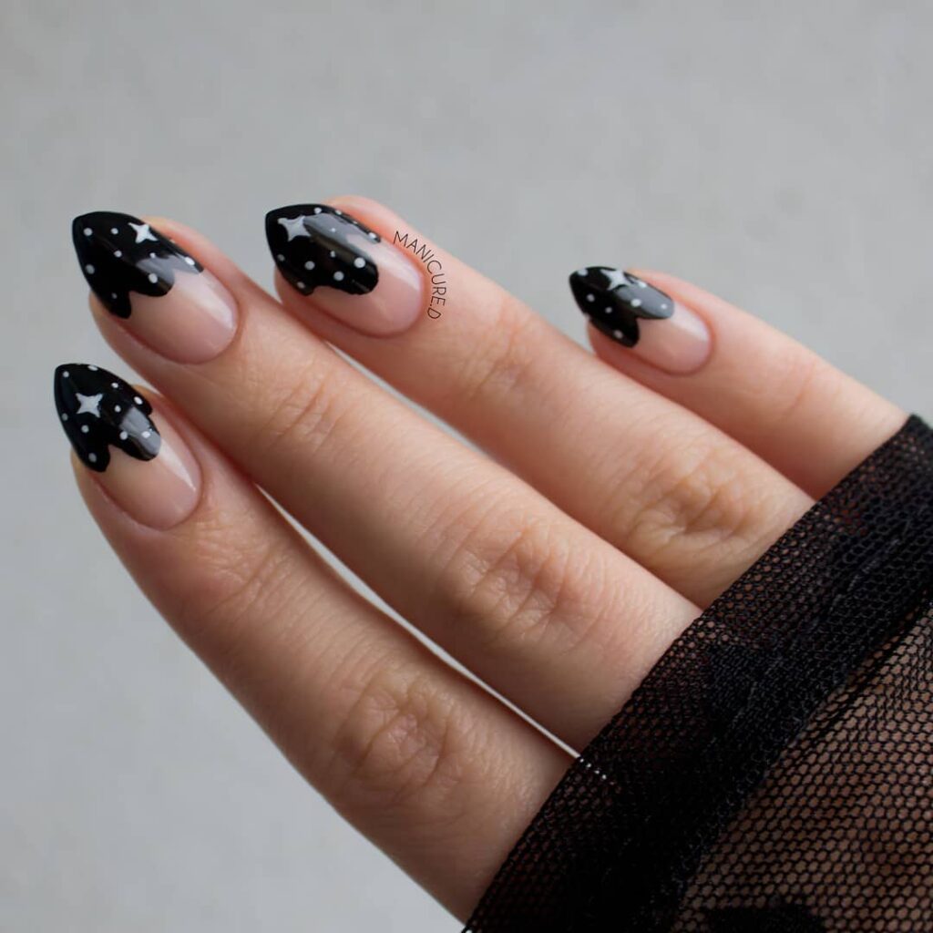 Celestial Almond Black Drip Nails with Stars on Nude Base