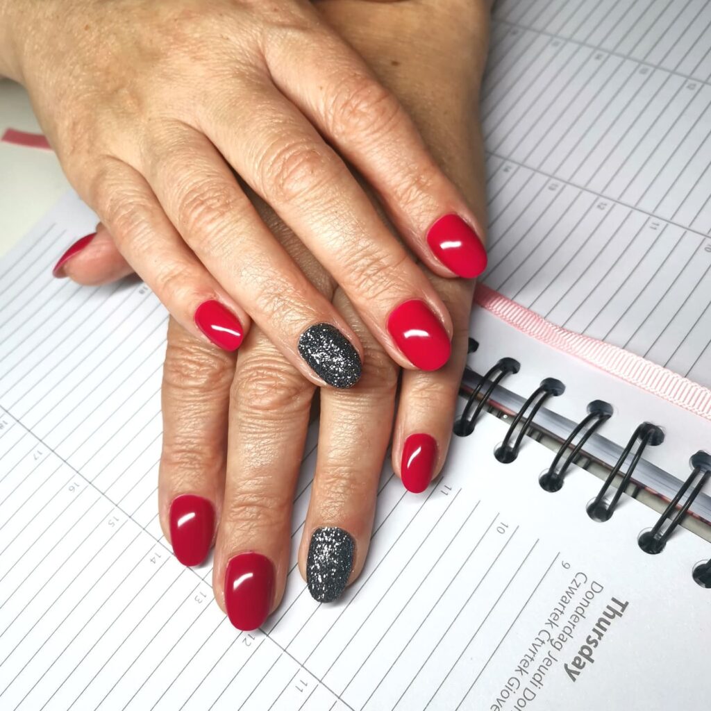 Cherry Red Oval Nails with Black Glitter Accents for Elegant Holiday Nail Ideas