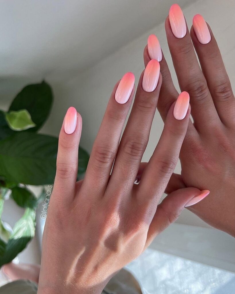 Choose oval ombré nails in pink and peach tones for a fresh and feminine summer vibe