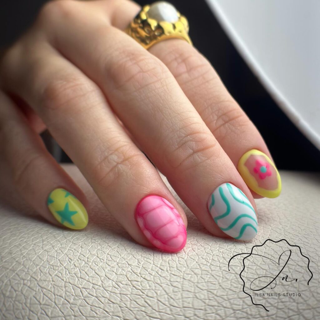 Colorful almond nails with graphic tips and floral accents matte nail art inspiration