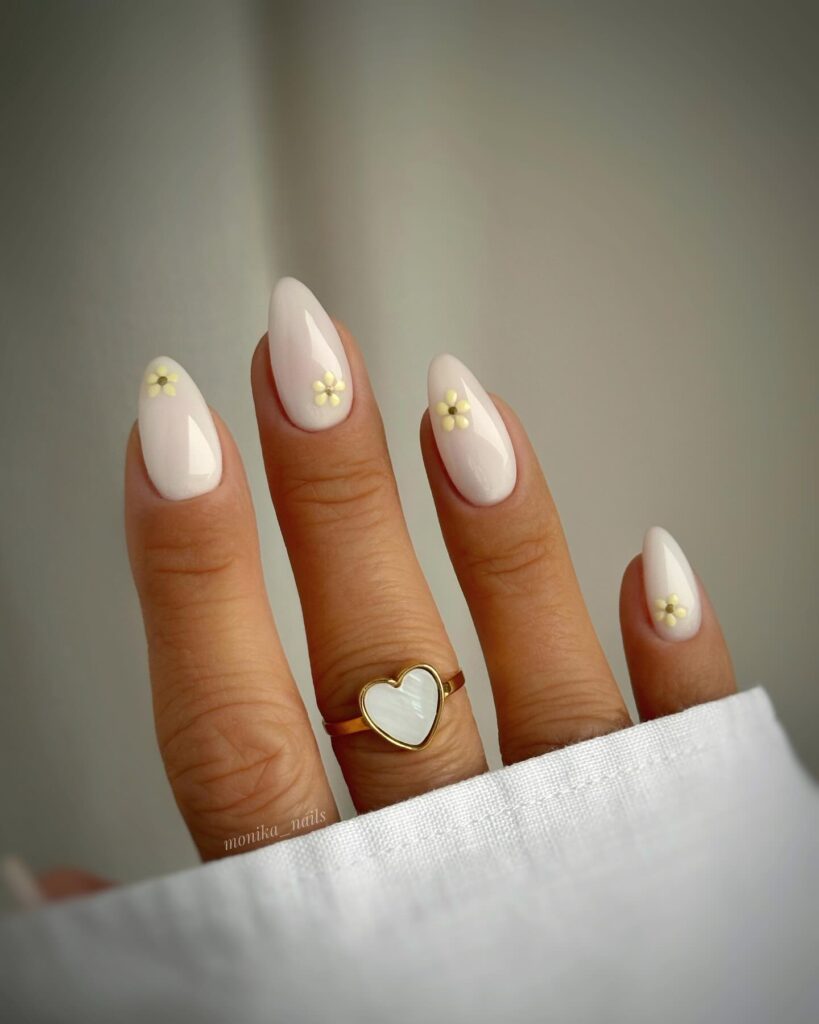 Creamy White Almond Nails with Minimal Daisy Details for a Timeless Spring Style