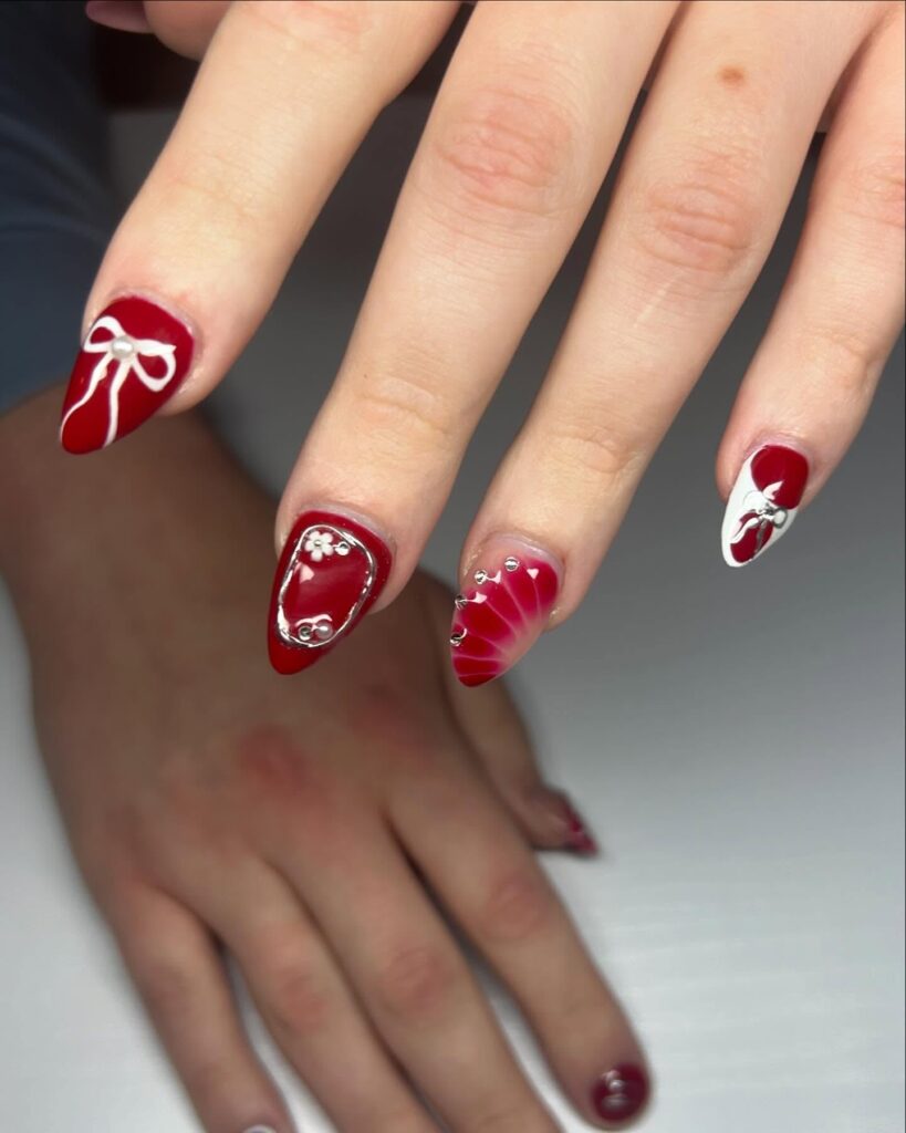 Deep red nails with 3D flowers and pearls for elegant graduation inspiration