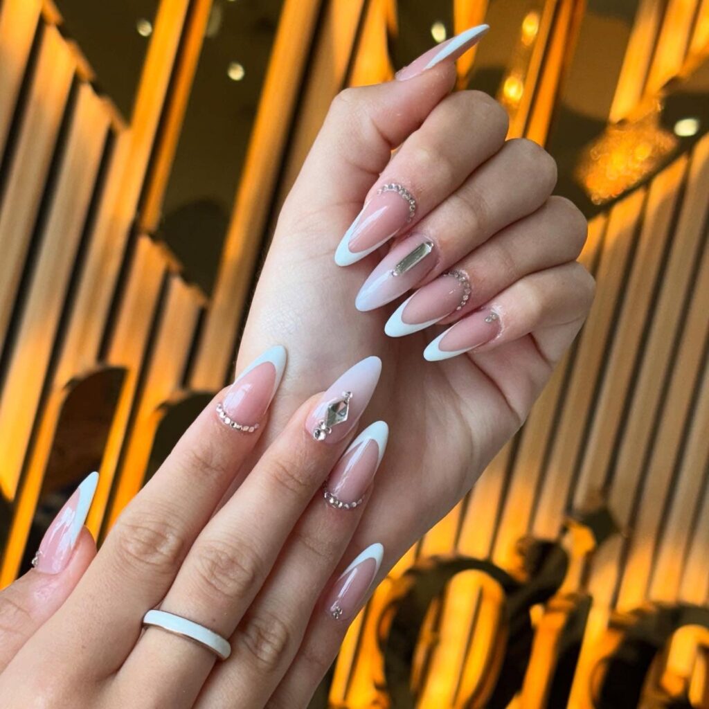 Elegant French Stiletto Birthday Nails with Crystals and Nude Shine