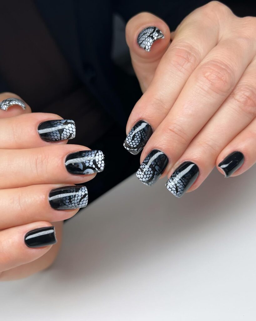 Elegant short black nails with white and silver lace nail art for feminine and sophisticated manicure ideas