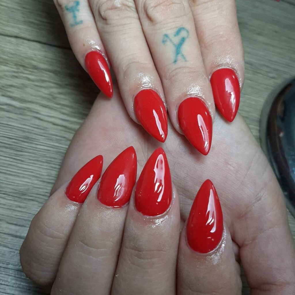 Fiery Glossy Red Stiletto Nails for a Fierce, Minimalist Statement
