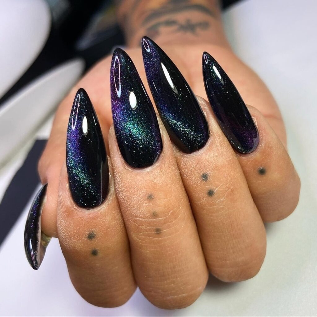 Galaxy Stiletto Black Nails with Holographic Tips and Glitter Accents