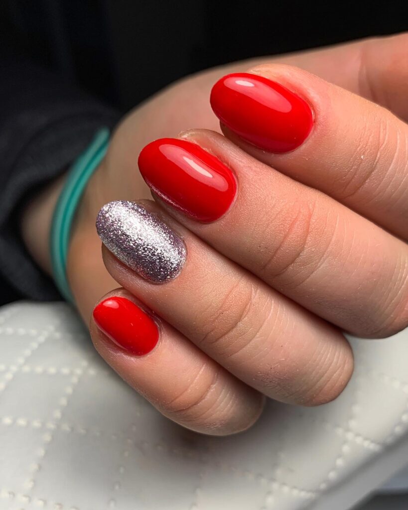 Glossy Oval Red Nail Ideas with Silver Glitter Accents for Special Occasions