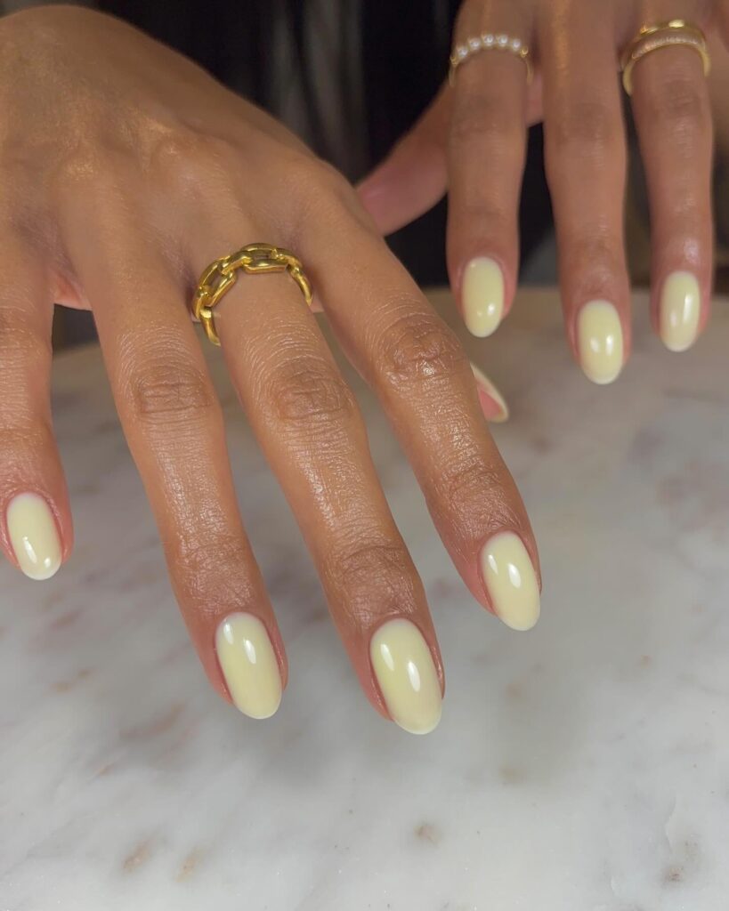 Glossy Pale Yellow Oval Nails for a Timeless and Feminine Nail Idea