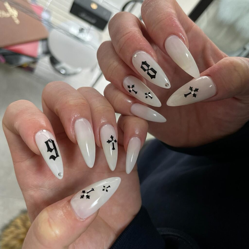 Gothic white almond nails with black accents and sparkle for edgy nail ideas