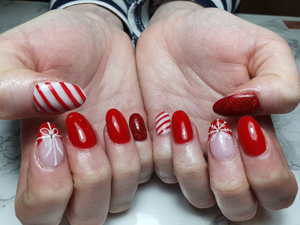 Holiday Red Nails with Bows Snowflakes and Glossy Finishes for Christmas Nail Art Ideas