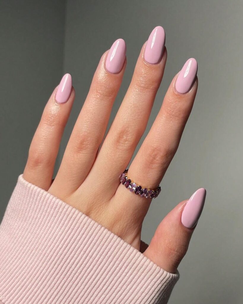 Keep it romantic with glossy almond nails in soft lilac pink for a clean and elegant finish