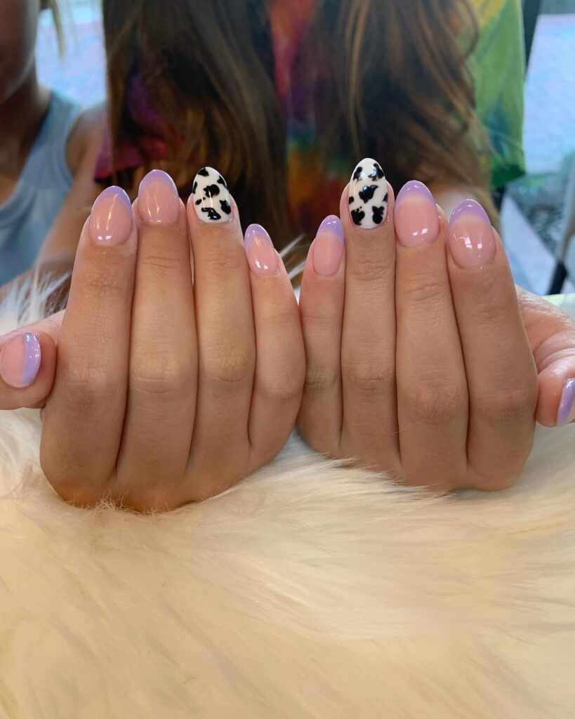 Lavender French almond nails with cow print accents for a fun graduation look