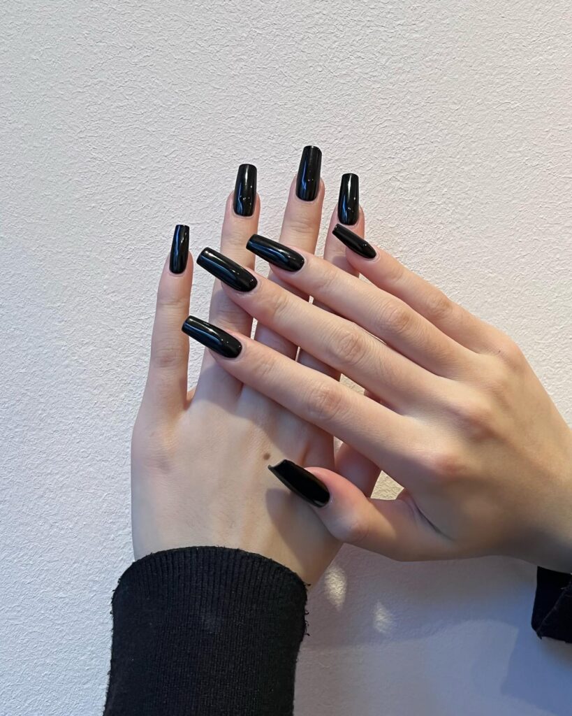 Long black coffin ballerina nails with a high-shine finish for a bold and modern minimalist nail idea