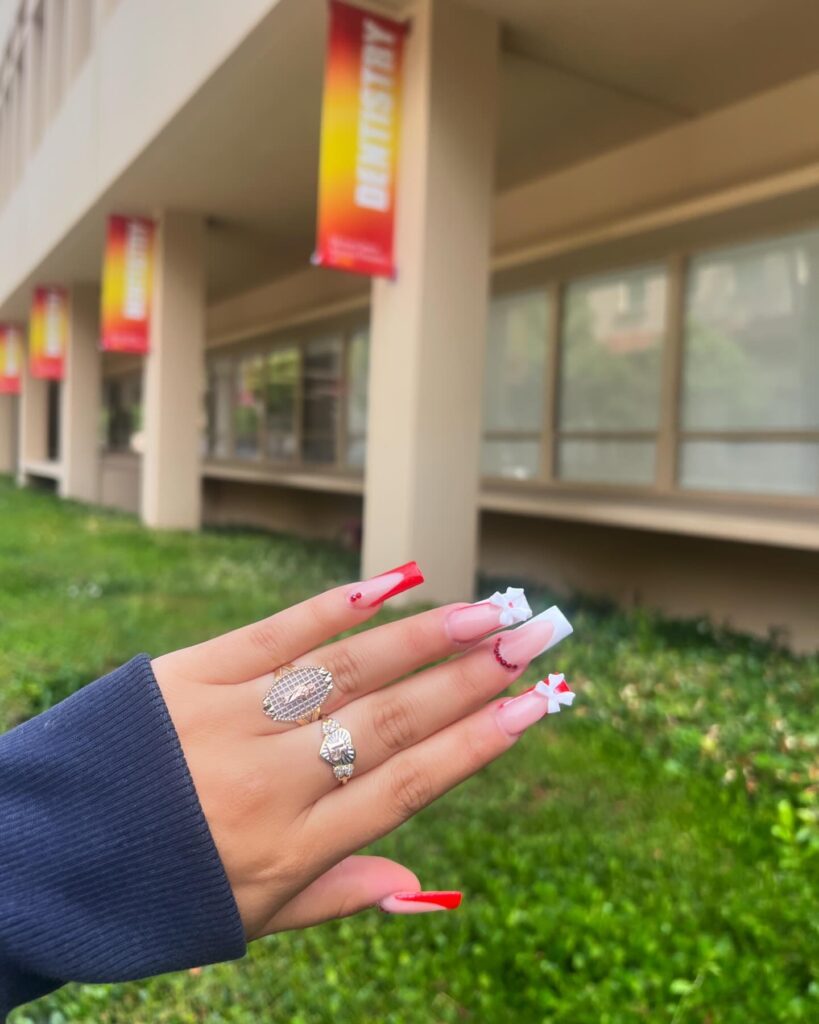 Long square red and nude graduation nails with French tips and 3D bows