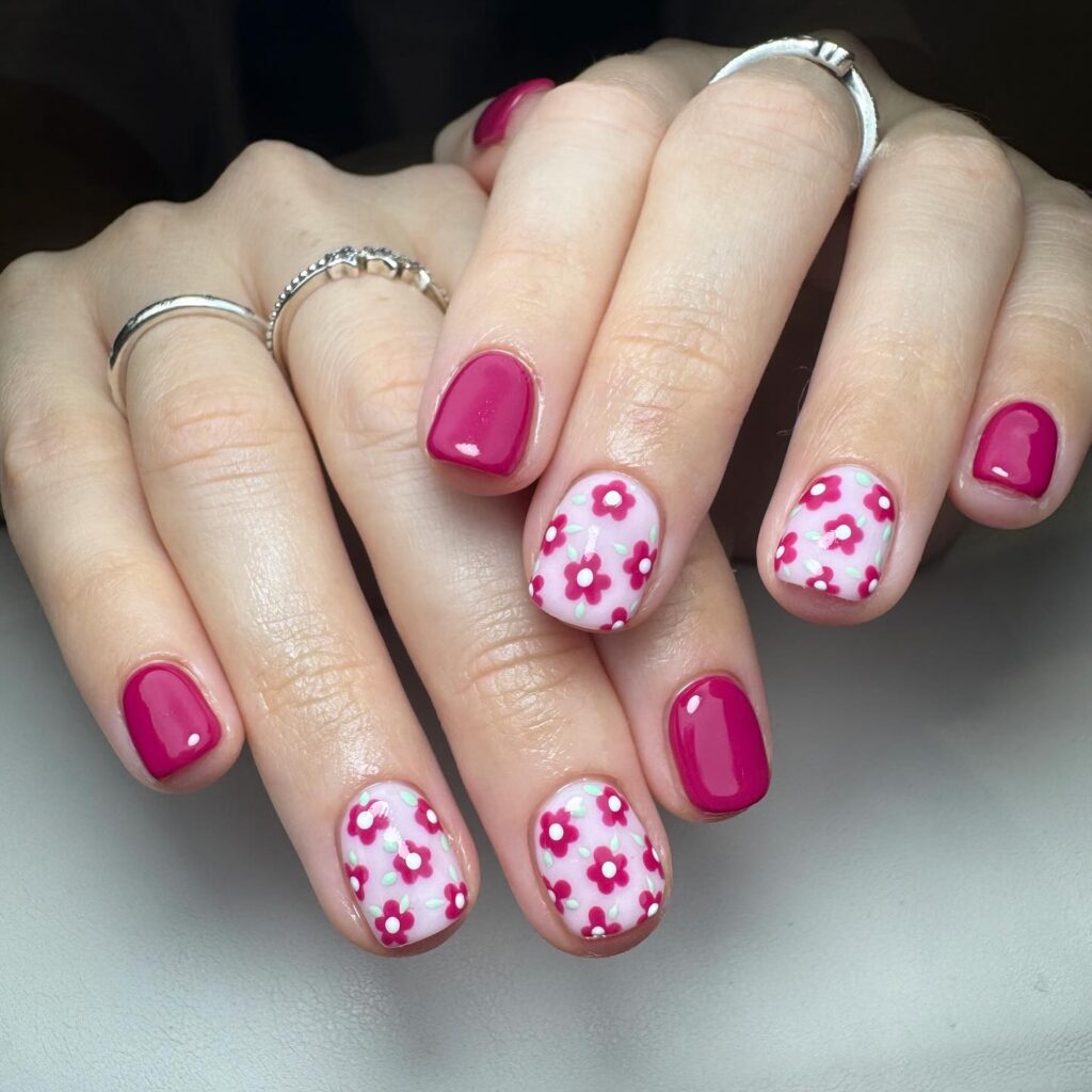 Magenta pink nails with daisy floral accents for bright spring nail designs