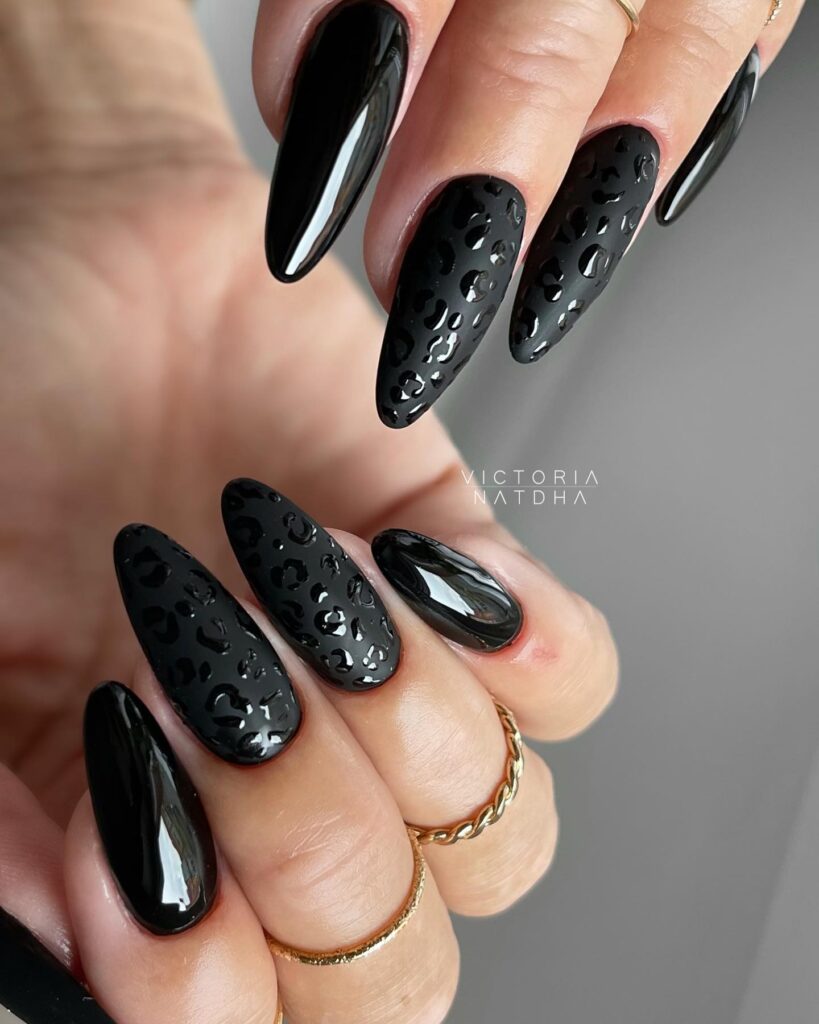 Matte and glossy black almond nails with tone-on-tone leopard print for trendy and chic nail art ideas