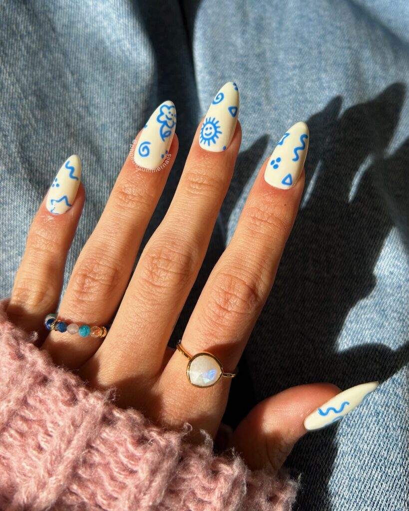 Matte Ivory Nails with Cobalt Blue Doodles for a Fun and Minimal Summer Sketch Look
