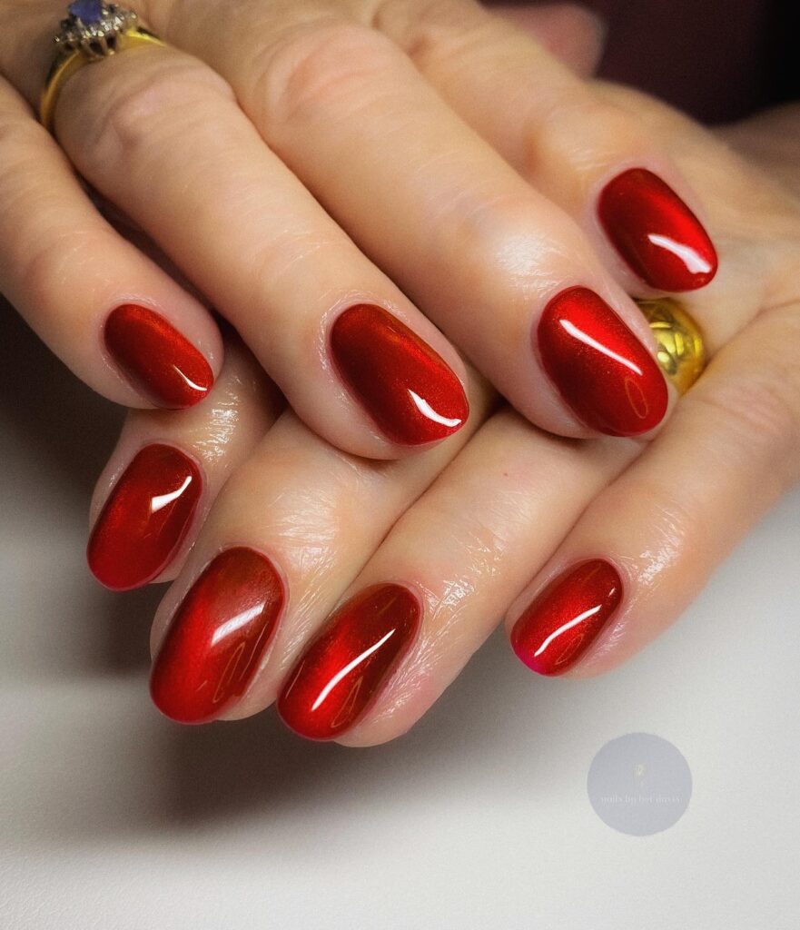 Metallic Red Oval Nail Ideas with Cat-Eye Shimmer for Festive Glamour