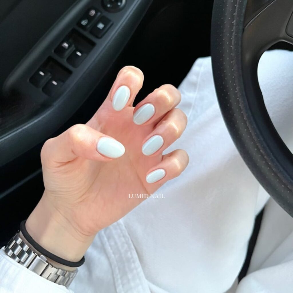 Minimalist Almond Short Nails with Icy Blue Gloss for a Chic Everyday Look