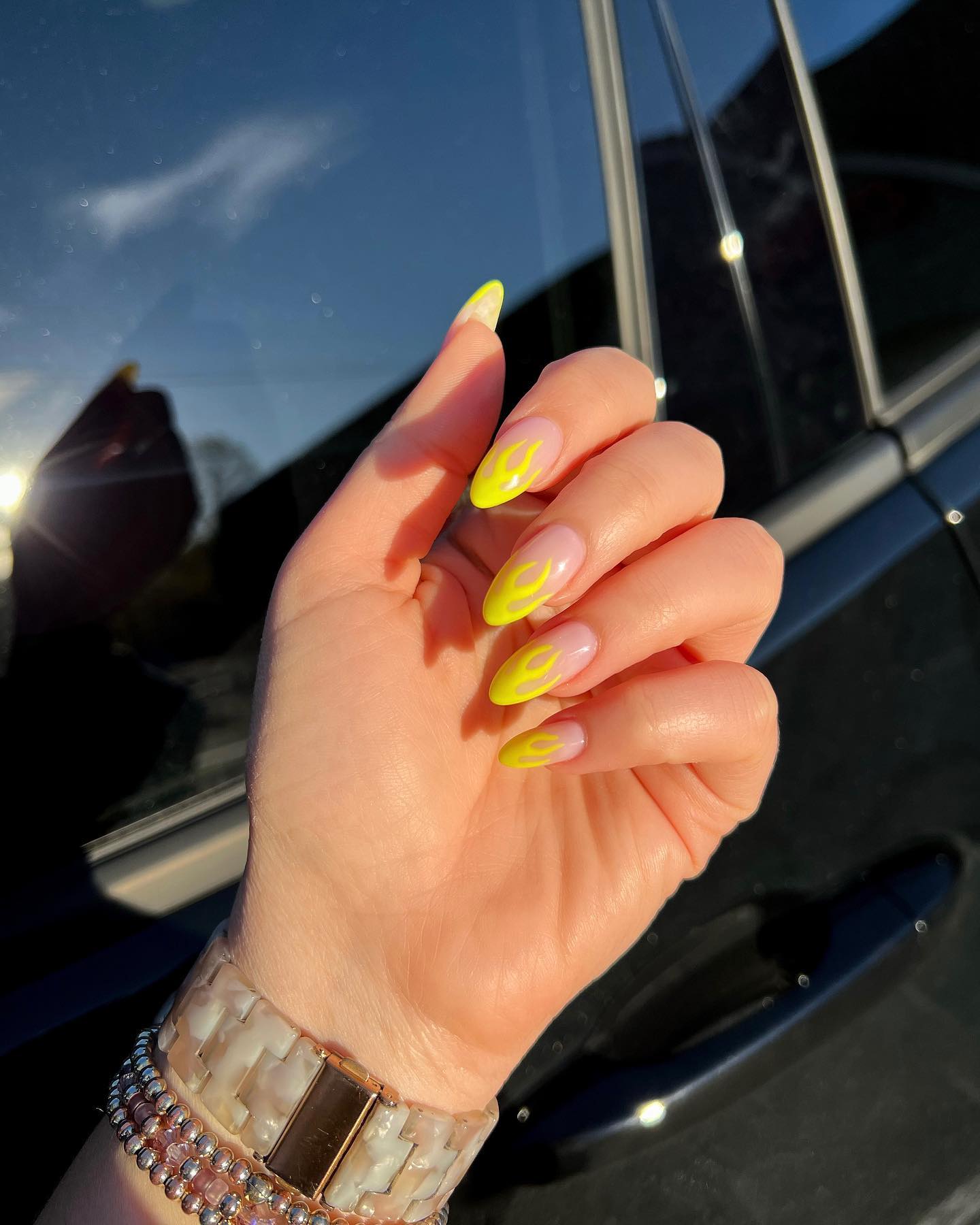 Modern Neon Yellow Abstract Swirl Nails on Nude Pink Almond Shape for Edgy Nail Ideas
